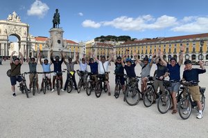 A group of people on bicycles posing for a photo.