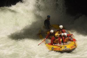 A group of people rafting down a river.