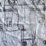 Crinkled sheet of paper with hand-drawn, child-like sketches and scribbles.