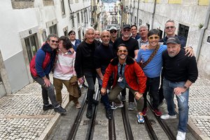 A group of people posing for a photo on a cable car.