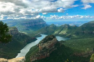 Show thumbnail preview	 A scenic viewpoint overlooking a river winding through a lush canyon with steep cliffs under a partly cloudy sky.