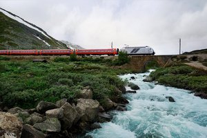 A train on a bridge over a river.