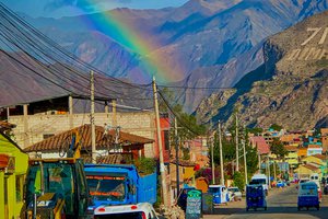 A rainbow over a city street.