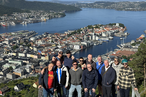 Group of men atop mountain over Bergen Norway